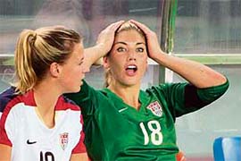 Replaced US goalkeeper Hope Solo (right) sits on the bench with teammate Aly Wagner
