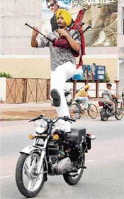 Punjab Police jawan Manjinder Singh Bagga (23) of Patiala performs stunts on a motorcycle on the occasion of the 100th birth anniversary of Shaheed Bhagat Singh in Amritsar on Saturday. 