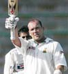 South Africa's Jacques Kallis waves his bat after scoring a century against Pakistan during the first day of their first Test cricket match at National Stadium in Karachi 