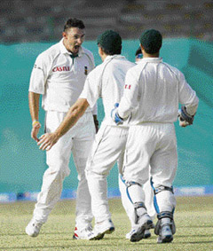 South Africa's Andre Nel (L) celebrates the dismissal of Pakistan's Younus Khan with Graeme Smith (C) and Mark Boucher on the second day of the first Test