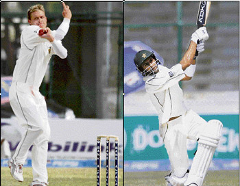 South Africa�s Paul Harris (L) took five wickets in Pakistan�s first innings and Shoaib Malik (R) hits a six to complete his 1,000 runs in Tests during the third day�s play of the first Test match in Karachi on Wednesday. 