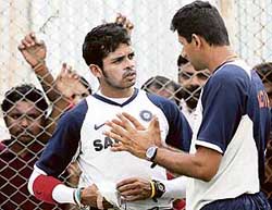 Will Prasad succeed? Sreesanth (L) listens to bowling coach Venkatesh Prasad (R) during a training session.