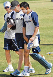 Gautam Gambhir, accompanied by physio John Gloster and manager Lalchand Rajput, being taken out of the net practice area after the batsman sustained a groin injury during the practice session at the Sector 16 cricket stadium at Chandigarh on Sunday.