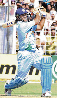 Mahendra Singh Dhoni hits a last-ball six off the bowling of Australia�s Nathan Bracken during the fourth one-dayer at the Sector 16 Cricket Stadium in Chandigarh on Monday
