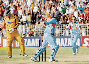 Murali Kartik (right) celebrates after taking the wicket of Matthew Hayden (left). 