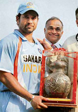 Sachin Tendulkar holds the trophy presented to him by the Baroda Cricket Association for reaching the milestone of 400 one-dayers at Vadodara on Thursday.