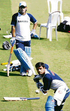 Mahendra Singh Dhoni (L) watches as Rahul Dravid bats during a training session at the Vidarbha Cricket Stadium in Nagpur on Saturday on the eve of the sixth one-day match between India and Australia. 