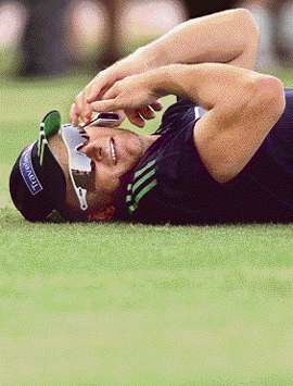 Australian cricketer Adam Gilchrist speaks on a mobile phone during a break in training session at the Vidarbha Cricket Stadium in Nagpur on the eve of the sixth One-day International match between India and Australia. Australia leads the seven match ODI series 3-1, with the first match abandoned due to rain.