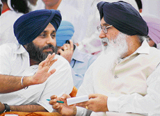 Chief Minister Parkash Singh Badal in discussion with working president of the SAD Sukhbir Singh Badal at a private function in Bathinda on Sunday