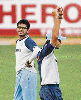 S Sreesanth (L) watches teammate Rahul Dravid exult after winning a game of throw-ball during a training session on Tuesday at the Wankhede stadium, on the eve of the final one-day international match between India and Australia in Mumbai