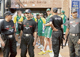 Pakistan police commandos stand guard as South African cricketers arrive for a practice session at the Gaddafi Stadium in Lahore on Friday.