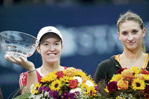 Justine Henin (left) holds the trophy after beating Tatiana Golovin in the final of the Zurich Open tennis tournament on Sunday.