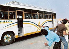 Two persons throw stones at a bus which crushed a boy to death in Bathinda