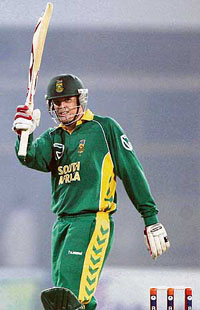 Shaun Pollock raises his bat after making a half century during the fourth one day international match between Pakistan and South Africa in Multan on Friday.