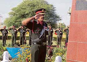 Major-Gen R.H. Vardhan salutes at the War Memorial on Infantry Day in Gurdaspur