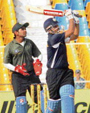 India Blue captain Virender Sehwag plays a shot as India Green wicketkeeper Parthiv Patel looks on during the Challenger Trophy match at the Sardar Patel Stadium in Motera, near Ahmedabad, on Saturday.