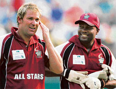 Shane Warne (left) and Brian Lara of the All Stars team chat during their Hong Kong Cricket Sixes match against South Africa on Saturday.