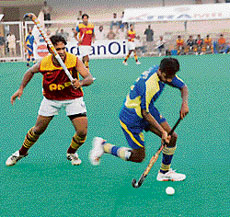 A match between Punjab National Bank and Bharat Petroleum in progress during the 24th Indian Oil Surjit Hockey Tournament in Jalandhar on Saturday.