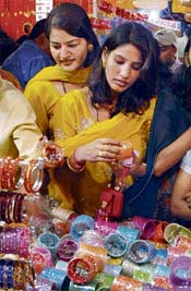 Women check out colourful bangles on the eve of Karva Chauth in Amritsar on Sunday.