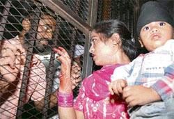 A woman, along with her child, during a special meeting with her husband on the occasion of Karva Chauth at the Central Jail in Amritsar