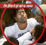 A policeman attends to cricketer Praveen Kumar after he fell from a jeep on his arrival in Meerut on Monday.