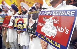 Activists of the Dal Khalsa hold placards as they take part in the Punjab Jagao March on the eve of the 41st Punjab Day in Amritsar