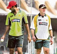 In this file picture dated August 27, 2007, Pakistan cricket coach Geoff Lawson (R) walks with cricketer Rao Iftikhar during a practice session at The Gaddafi Stadium in Lahore.
