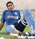 Indian skipper M. S. Dhoni rests during the practice session ahead of the Indo-Pak series in Kolkata
