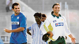 India's Zaheer Khan and Pakistan's Shoaib Akhtar (R) joke during a cricket training session in Guwahati on Sunday.