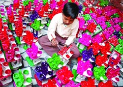 A child painting earthen lamps for sale to make Diwali colourful in Bathinda on Monday.