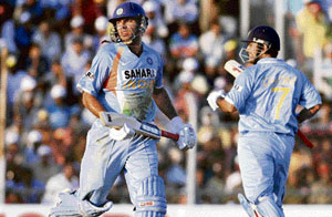 Yuvraj Singh (L) and team captain Mahendra Singh Dhoni (R) snatch a quick single during the first one-day international between India and Pakistan at Nehru Stadium in Guwahati.