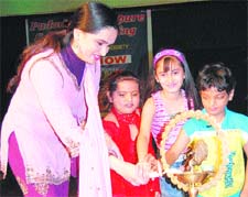 Bollywood actress Padmini Kolhapuri lights a lamp to innaugurate a function in Amritsar.