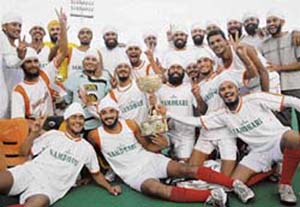 Namdhari players celebrate with the trophy after beating Indian Airlines in the final of the 37th SN Vohra�s All-India Gurmit Hockey Tournament at the Sector 42 Hockey Stadium in Chandigarh on Monday. 