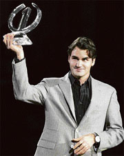Roger Federer of Switzerland holds the trophy for the 2007 season winner during a ceremony at the Tennis Masters Cup Shanghai on Tuesday.