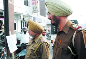 Policemen reading the warning letter at Mall Road in Bathinda