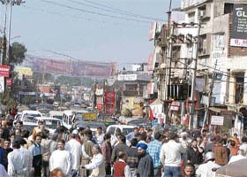 Shopkeepers block the Amritsar-Pathankot-Kullu highway in protest against the local administration for constructing a divider in Pathankot