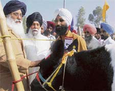 Punjab Chief Minister Parkash Singh Badal (left) and cooperation minister Kanwaljit Singh take a look at milch cattle at a fair as part of the 54th National Co-operative Week in Mohali on Tuesday.