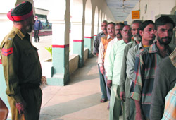 Voters queue up to cast votes in a polling station at the Bathinda railway station
