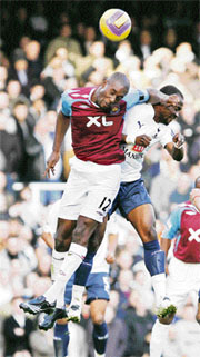 West Ham�s Carlton Cole (L) fights for the ball with Tottenham Hotspur�s Didier Zokora during their English Premier League soccer match at Upton Park in east London on Sunday.