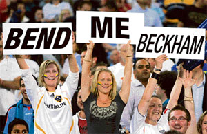 Fans of LA Galaxy captain David Beckham hold signs in the air before a friendly soccer match against Sydney FC in Sydney on Tuesday. 