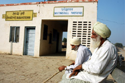 A Long Wait: Residents of village Daula Kotebhai sitting outside the railway station in the hope that some day a train will stop there