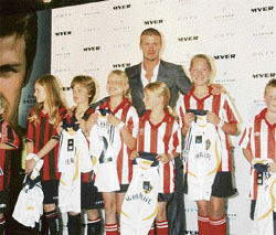 Former England soccer captain David Beckham poses with young socceroos during a promotional event to launch his new fragrance "Intimately Beckham Night" in Sydney on Wednesday.