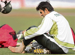 Pakistan captain Shoaib Malik tends to his injured ankle during a training session at The Eden Gardens Stadium in Kolkata