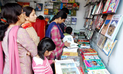 Visitors take a keen interest in books that have been exhibited at the book fair in Bathinda.