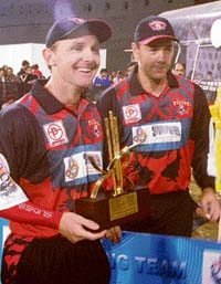 Darren Maddy (L) of Kolkata Tigers holds the Man-of-the-Match trophy as captain Craig McMillan looks on after their team beat Chandigarh Lions in the ICL Twenty20 match at the Tau Devi Lal Stadium in Panchkula on Sunday. 