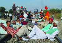 Members of Technical Services Union, BKU and other farmers� organisations staging a dharna at a railway crossing near the thermal plant in Bathinda on Wednesday.