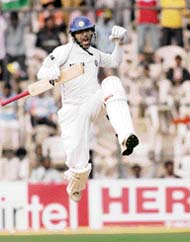 Yuvraj Singh celebrates on completing his ton on the first day of the third Test against Pakistan in Bangalore.