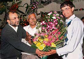 Kolkata Mayor Bikash Ranjan Bhattacharya (left) presents a bouquet to Sourav Ganguly as industries minister Nirupom Sen looks on during a felicitation programme in Kolkata on Thursday.
