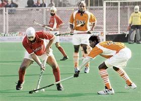 BSF and J&K players fight for the ball during the semifinal of the 56th All-India Police Hockey Championship at the Olympian Surjit Hockey Stadium in Jalandhar
