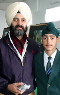 Nirlep Singh with his son Nirvair Singh in Bathinda on Thursday.